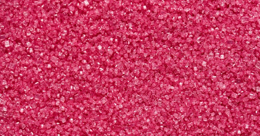 a close up of a pink glitter background